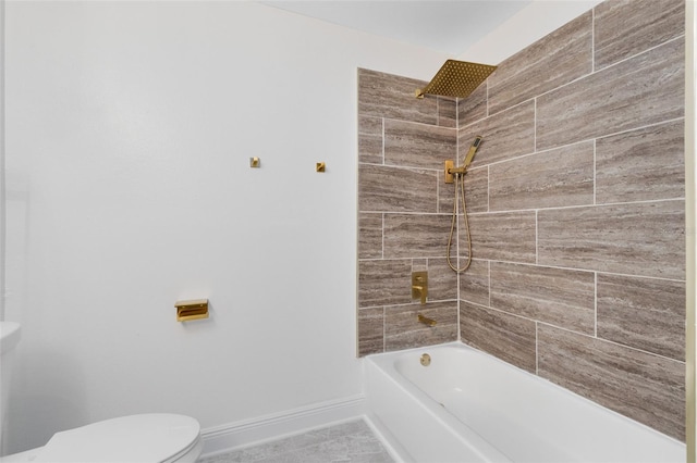 bathroom featuring tiled shower / bath and toilet