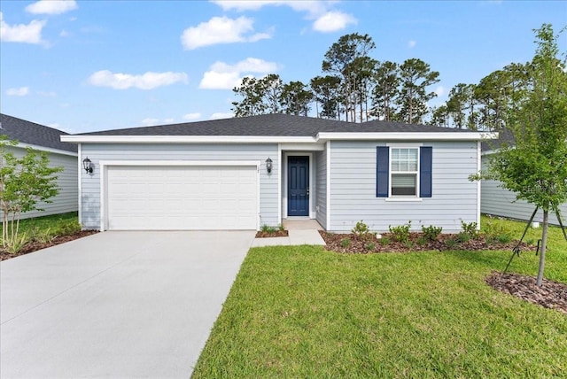 ranch-style house featuring an attached garage, driveway, and a front yard