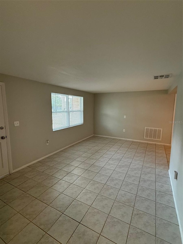 spare room featuring light tile patterned floors