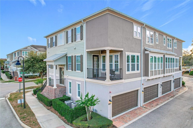 view of side of home featuring a garage and central air condition unit