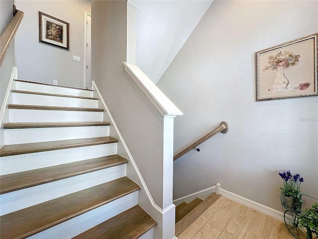 staircase with wood-type flooring