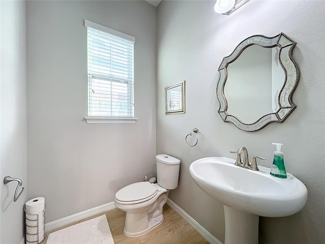 bathroom featuring hardwood / wood-style flooring, toilet, and sink