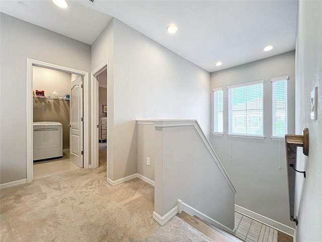 stairway featuring carpet and washer / clothes dryer