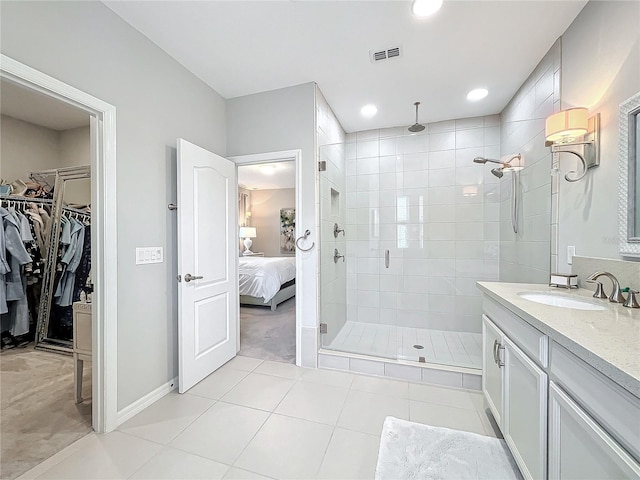 bathroom featuring tile patterned flooring, vanity, and an enclosed shower