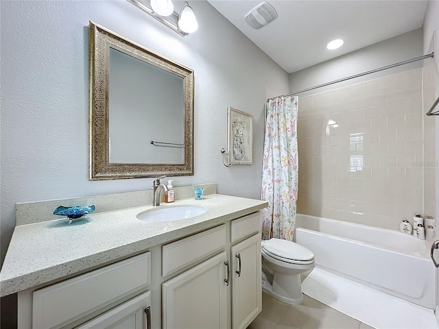 full bathroom with tile patterned floors, vanity, toilet, and shower / bath combo with shower curtain