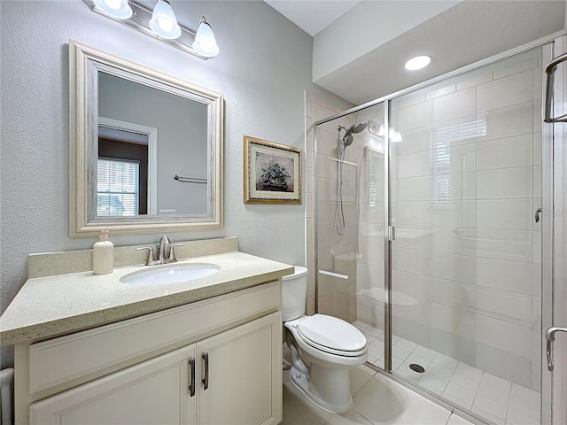 bathroom with vanity, toilet, and a shower with door