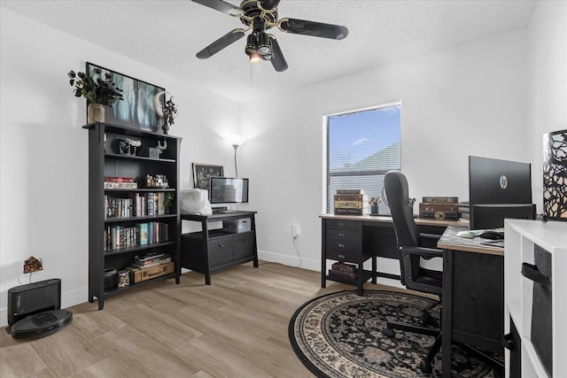 office space with ceiling fan, a textured ceiling, and light hardwood / wood-style flooring