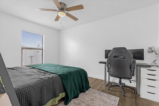 bedroom featuring ceiling fan and dark hardwood / wood-style flooring