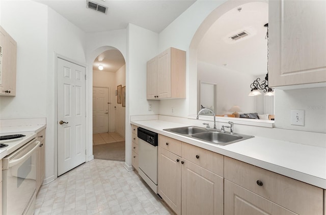 kitchen featuring sink, light brown cabinets, a notable chandelier, pendant lighting, and white appliances