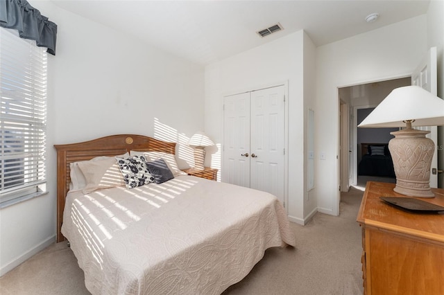 carpeted bedroom with a closet