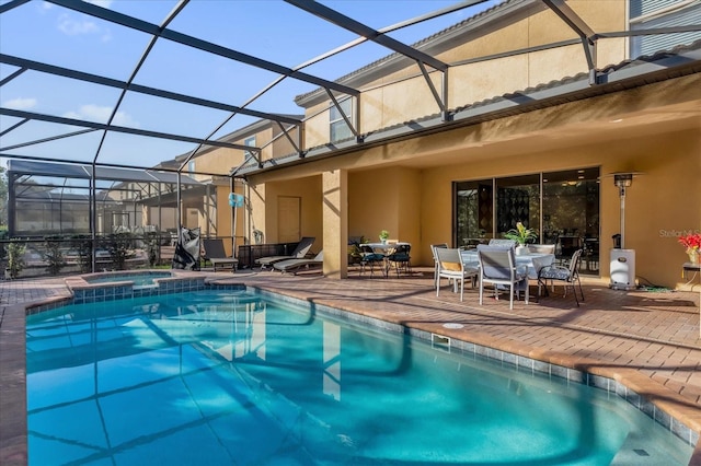 view of pool featuring a lanai, an in ground hot tub, and a patio