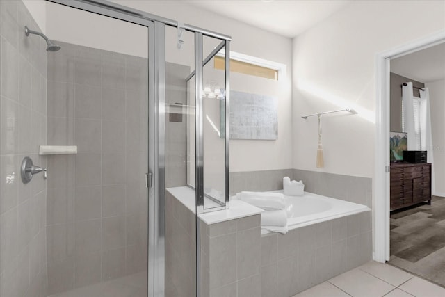 bathroom featuring tile patterned floors and independent shower and bath