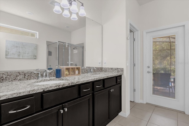 bathroom featuring tile patterned floors, vanity, a healthy amount of sunlight, and an enclosed shower