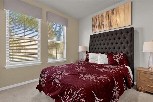 carpeted bedroom with multiple windows