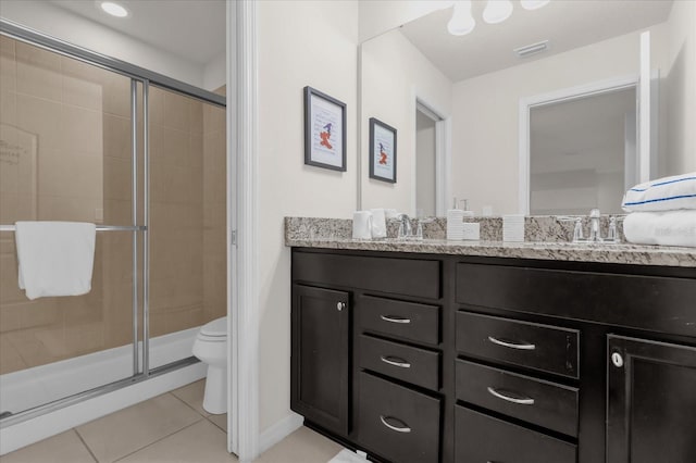 bathroom with tile patterned flooring, vanity, toilet, and walk in shower