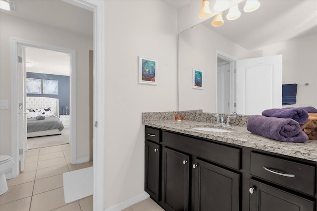 bathroom featuring toilet, vanity, and tile patterned floors