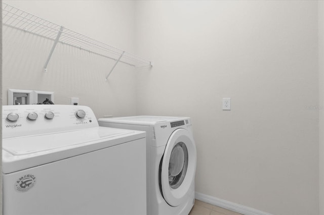 washroom featuring independent washer and dryer and light tile patterned floors