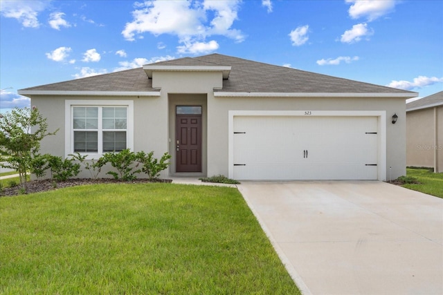 view of front of property with a front yard and a garage