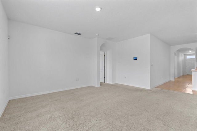 spare room with light colored carpet