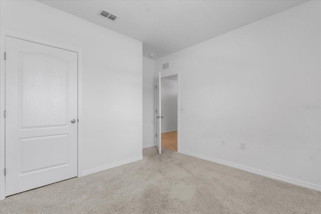 unfurnished bedroom featuring light colored carpet