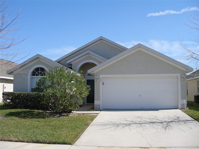 view of front of house featuring a front yard, a garage, and cooling unit