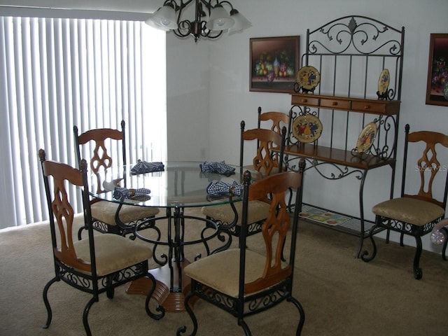 carpeted dining area featuring a chandelier