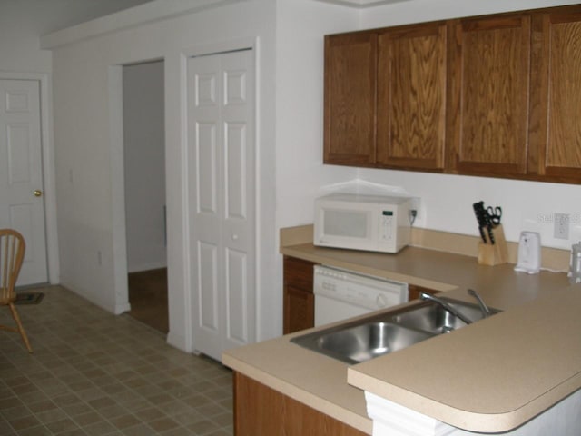 kitchen featuring sink and white appliances