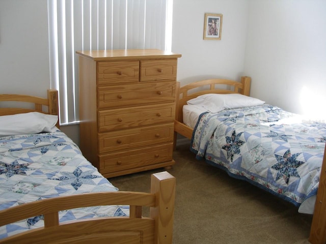 bedroom featuring dark colored carpet