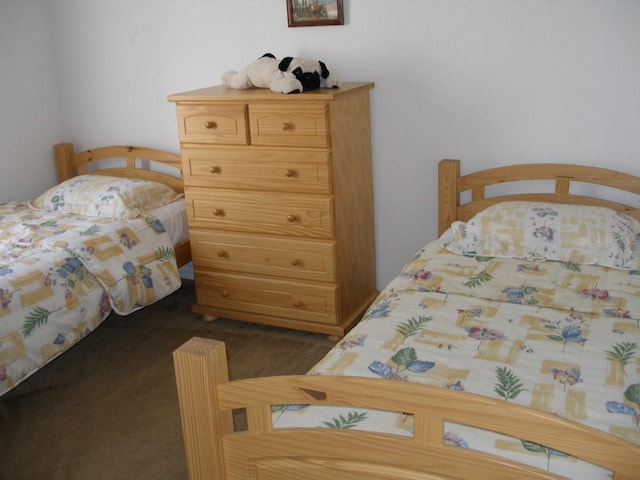 bedroom featuring dark carpet