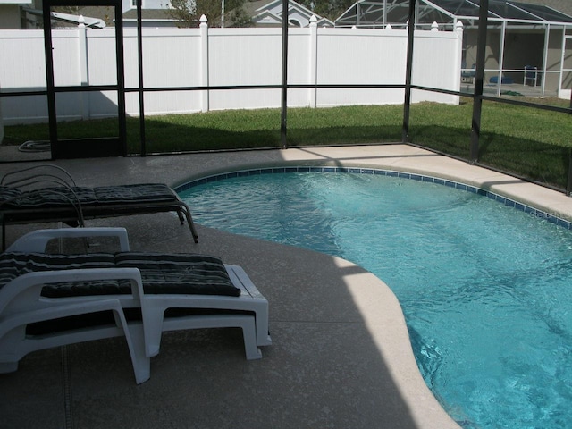 view of swimming pool featuring a lanai and a patio area