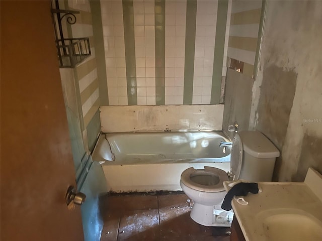 bathroom with tile patterned flooring, a bathing tub, vanity, and toilet