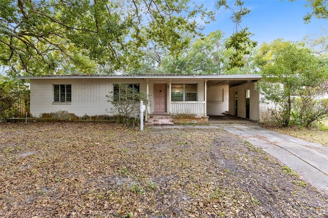 single story home with a porch and a carport