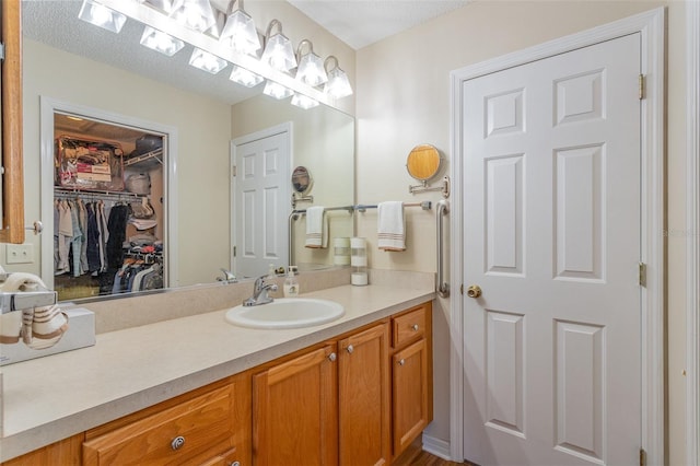 bathroom with a textured ceiling and vanity