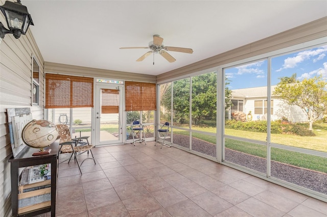 unfurnished sunroom with ceiling fan