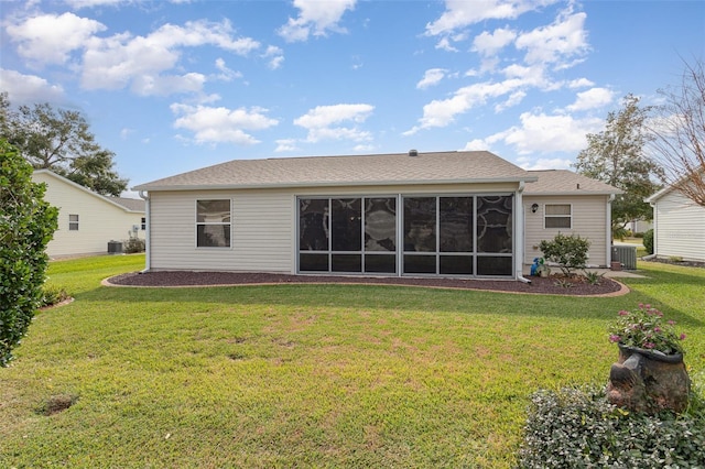 back of property with cooling unit, a lawn, and a sunroom