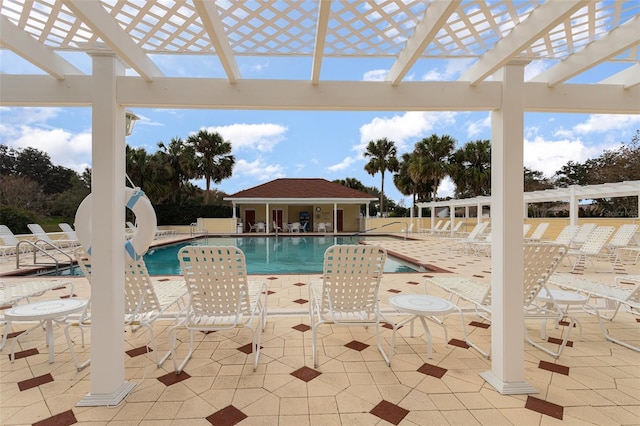 view of swimming pool featuring a patio area and an outdoor structure