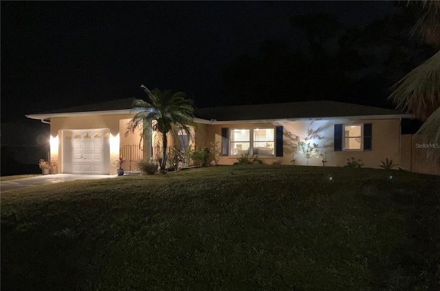 single story home with a yard and a garage