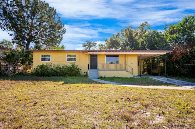 ranch-style house with a front lawn and a carport