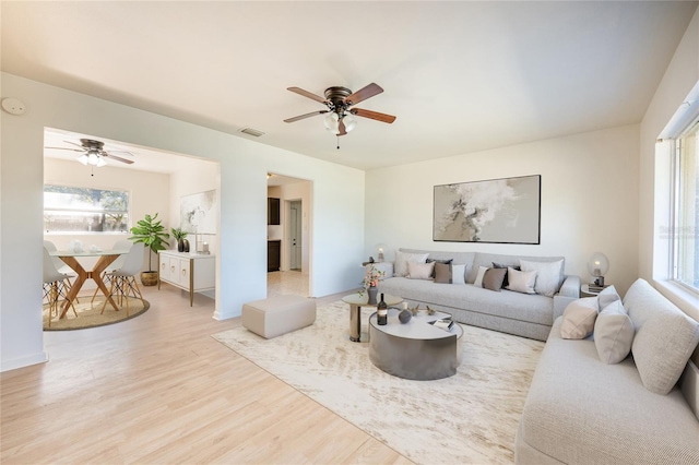 living room with ceiling fan and light wood-type flooring