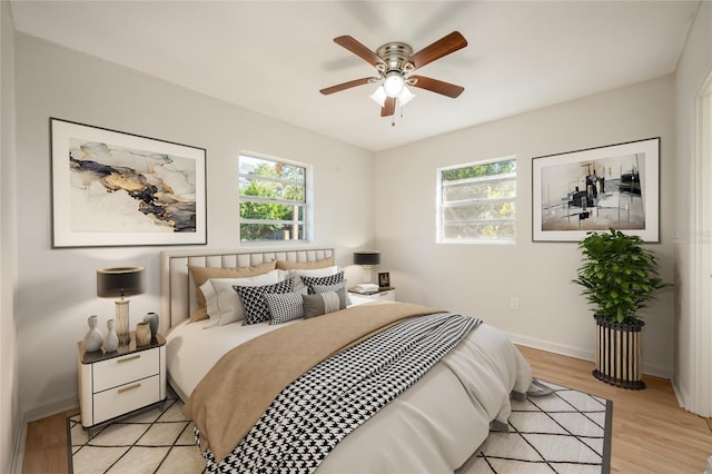 bedroom featuring light hardwood / wood-style flooring and ceiling fan