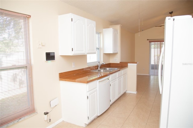 kitchen featuring vaulted ceiling, white appliances, sink, and white cabinets