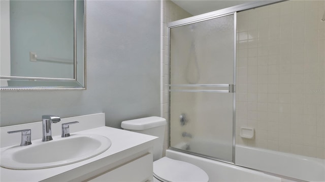 full bathroom with shower / bath combination with glass door, vanity, and toilet