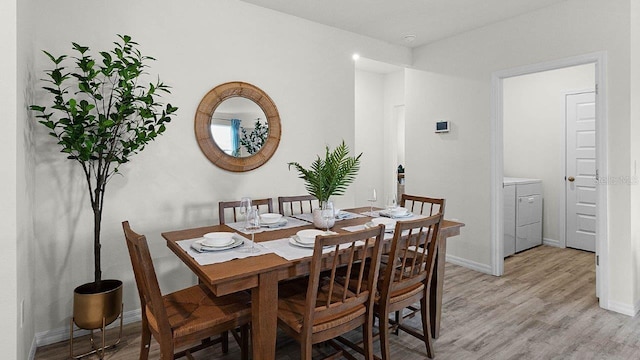 dining area with washer / clothes dryer and light hardwood / wood-style flooring