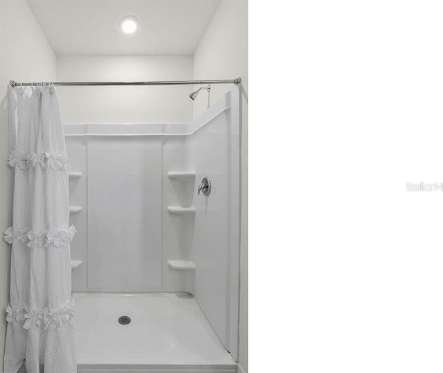 bathroom featuring a shower with curtain