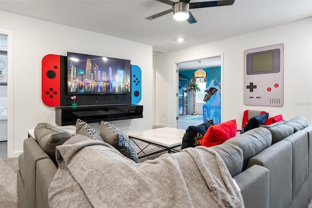 home theater room featuring ceiling fan and carpet