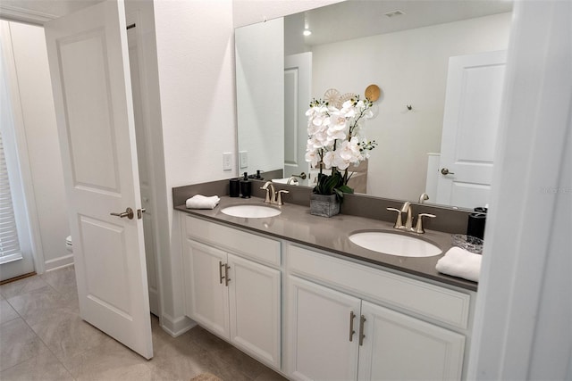 bathroom featuring tile patterned flooring and vanity