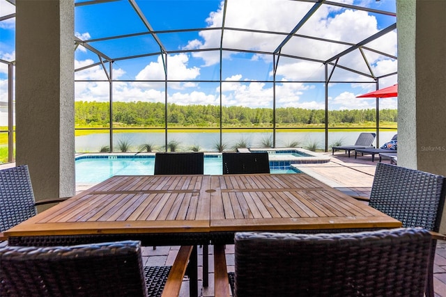 view of patio with glass enclosure, a water view, and a pool with hot tub