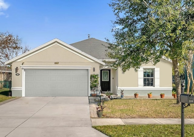 single story home featuring a garage and a front yard