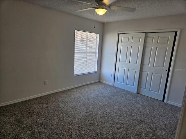 unfurnished bedroom with carpet, a textured ceiling, a closet, and ceiling fan