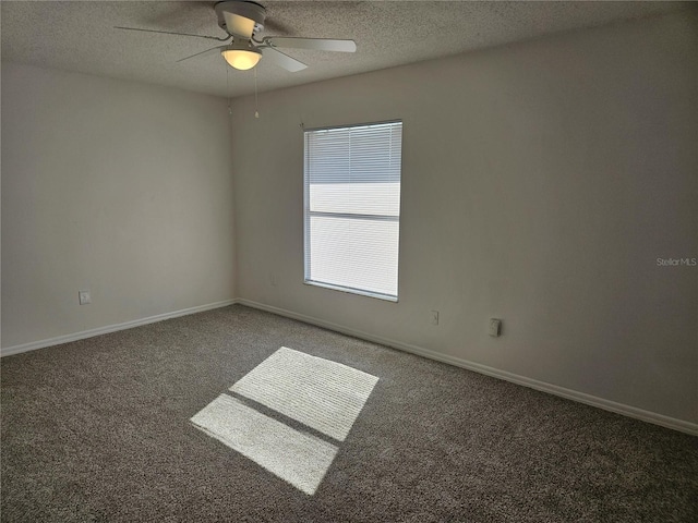 carpeted spare room featuring ceiling fan and a textured ceiling